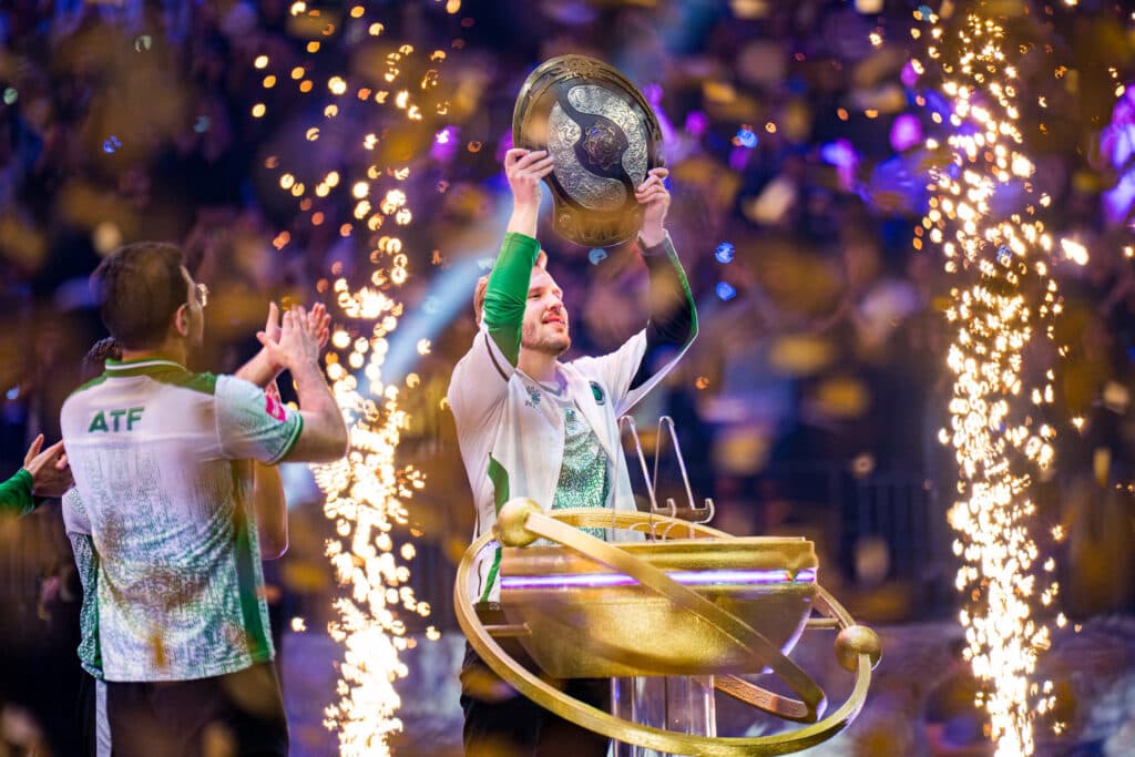 Crit holds up the Aegis of Champions at TI 2025 (Image via Valve)
