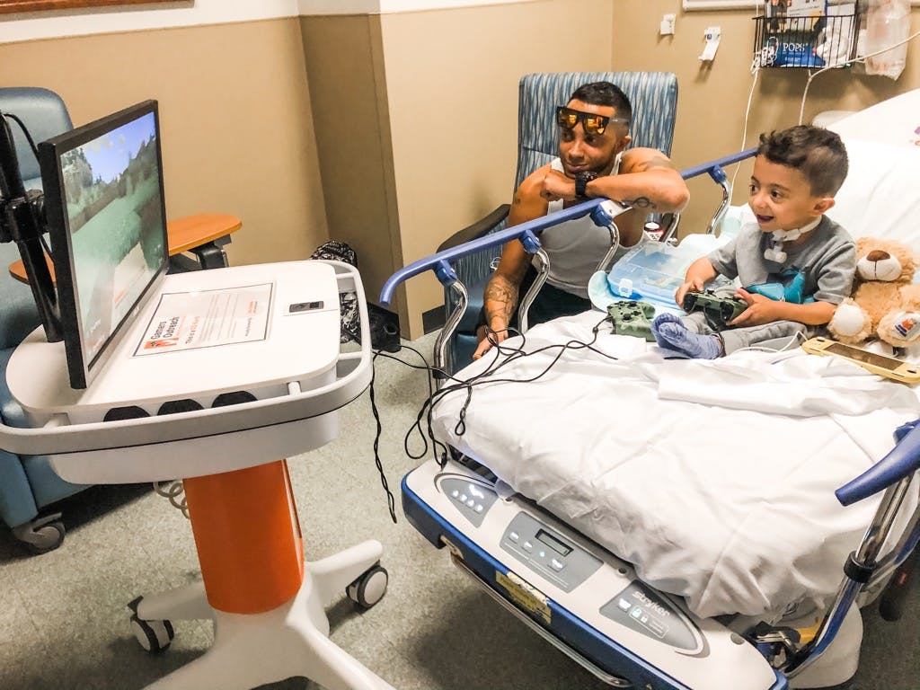 Gamers Outreach constructs gaming kiosks that can be wheeled into children's rooms for them to play from their bed