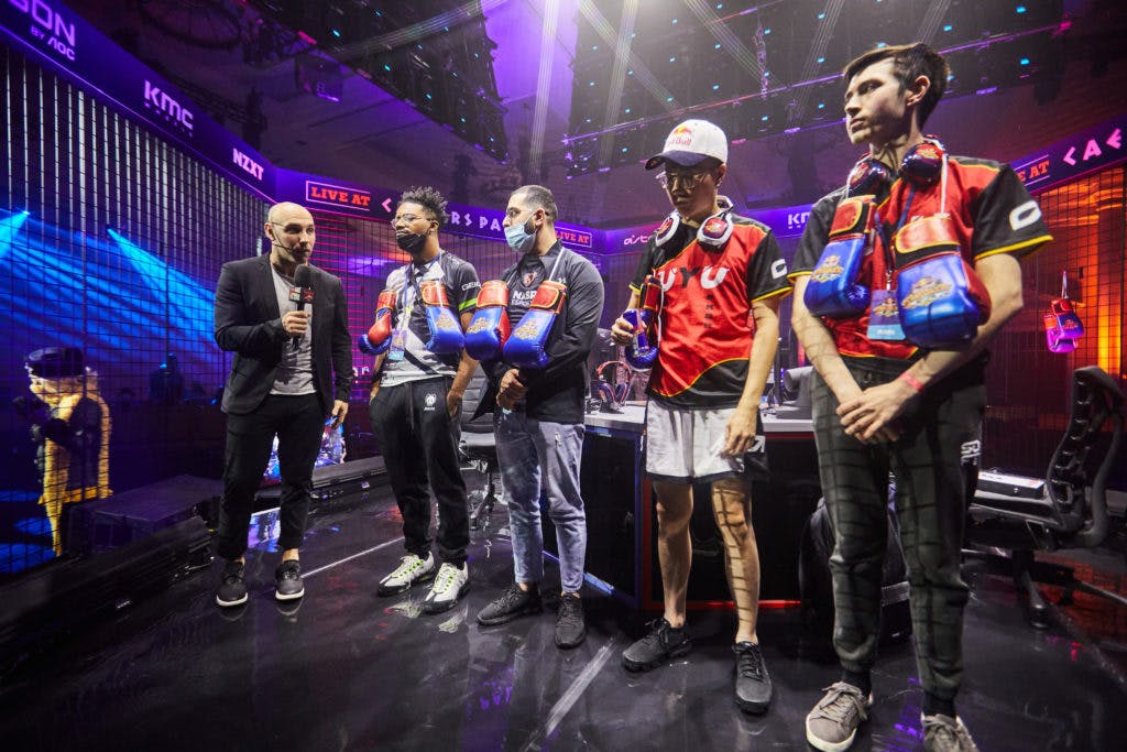 Victor 'Punk' Woodley, Amjad 'AngryBird' Al-Shalabi, Li Wei 'Oil King' Lin and Chris 'Chriscch' Hancock line up on stage following the completion of thei group the Street Fighter V competition at Red Bull Kumite, held in the Octavius Ballroom at Caesar's Palace in Las Vegas, NV, USA on 14 November, 2021. // <em>Marv Watson for Red Bull Content Pool</em>