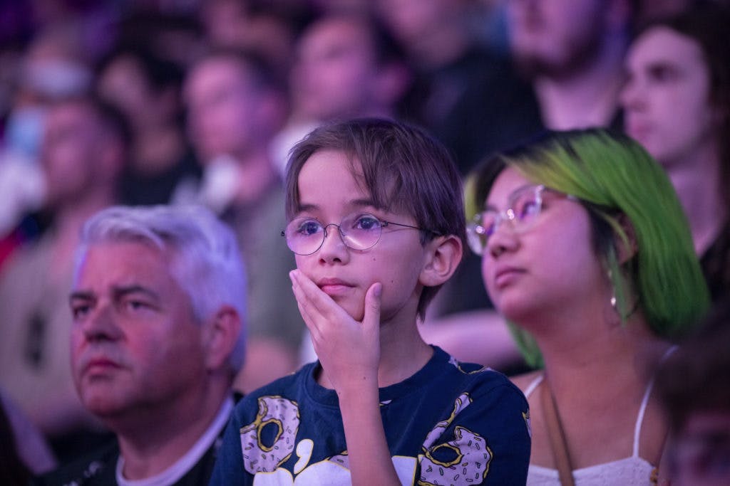A young player looks on as <a href="https://esports.gg/news/valorant/fpx-wins-vct-stage-2-masters-after-paper-rex-win/">FPX</a> and <a href="https://esports.gg/news/valorant/paper-rex-first-apac-history-valorant/">Paper Rex</a> battle it out in the VCT Masters 2 Copenhagen Grand Finals. Image Credit: Riot Games.