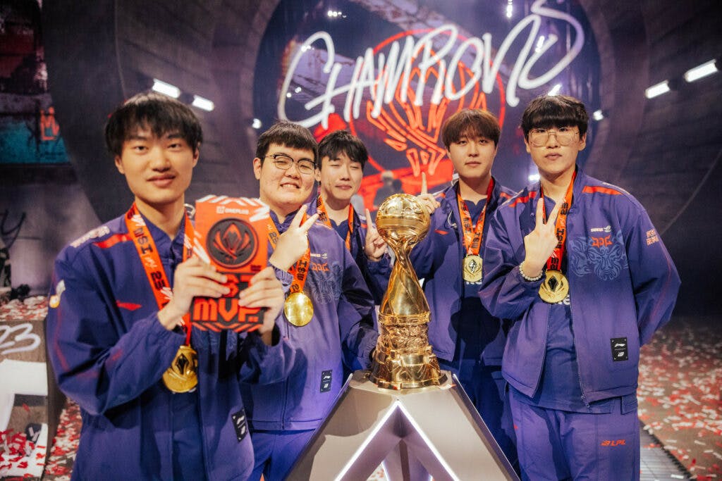 LONDON, ENGLAND - MAY 21: The JD Gaming Champions pose onstage with their trophy at the League of Legends - Mid-Season Invitational Finals on May 21 2023 in London, England. (Photo by Colin Young-Wolff/Riot Games)