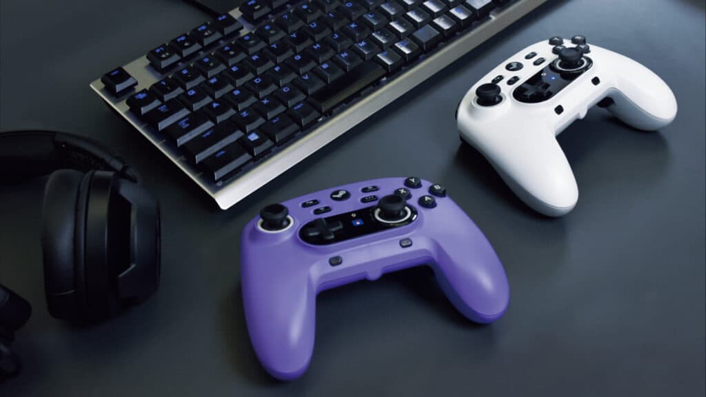 Two of HORI's Steam controllers next to headphones and a keyboard (Image via HORI)