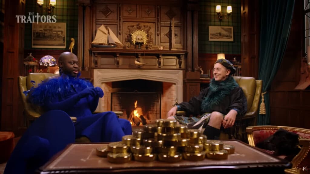 A scene from The Traitors Season 3 featuring contestant Bob the Drag Queen and host Alan Cumming (Image via Peacock)