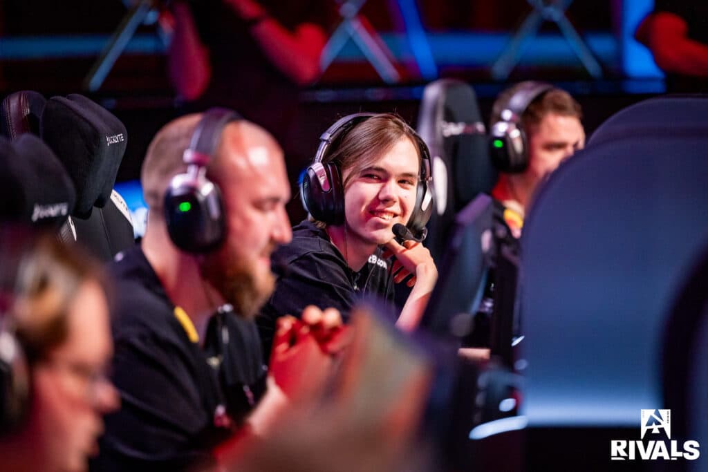 The photo features CS2 esports players from Team Spirit competing on the stage of BLAST Rivals Spring 2025.