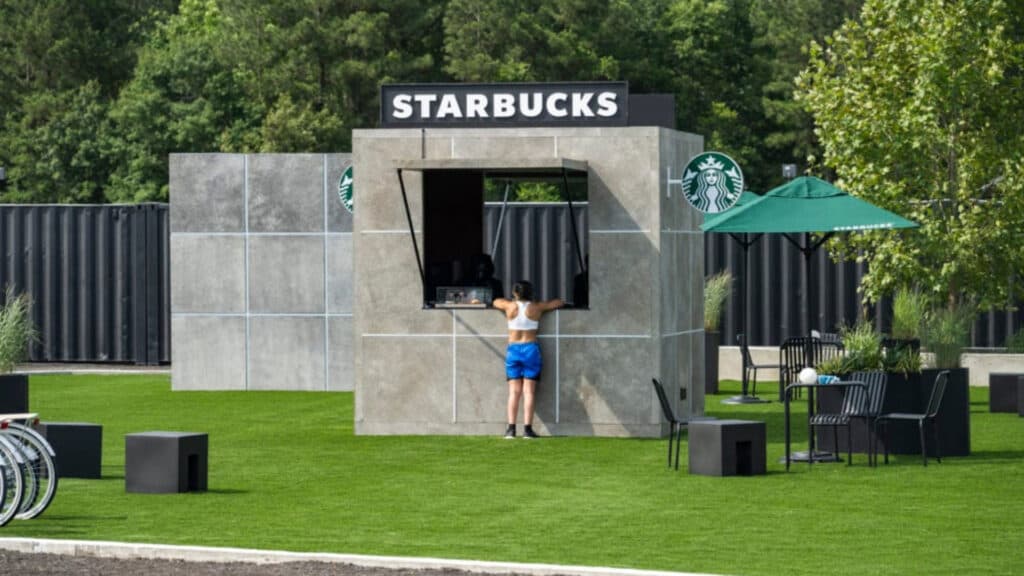 A Beast Games Season 2 contestant in front of Starbucks (Image via Starbucks)