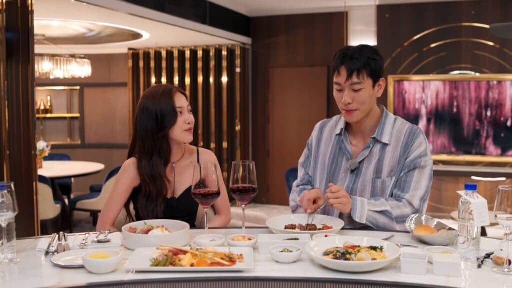 Lee Joo-young and Kim Jae-jin during their Paradise dinner (Image via Netflix)