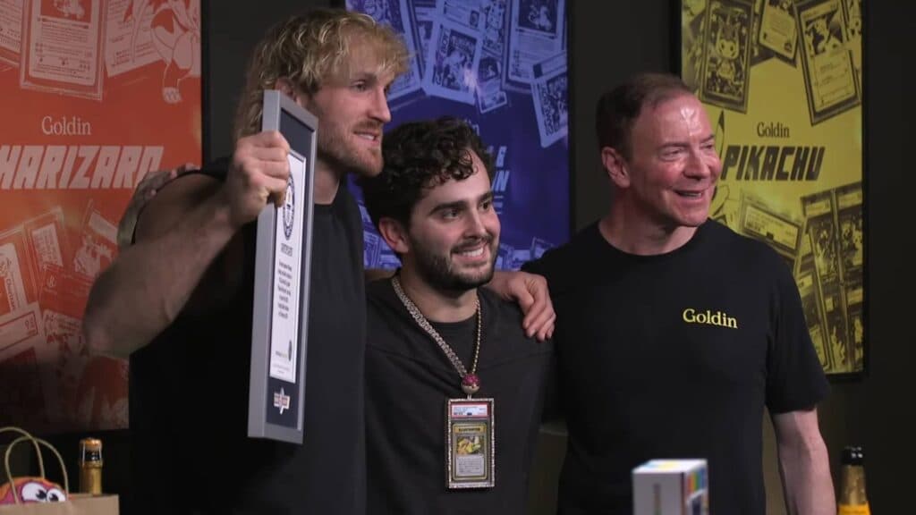 Logan Paul (left) takes a picture with AJ Scaramucci (middle), together with Ken Goldin, founder and CEO of Goldin Auctions (right) (Image via Logan Paul YouTube Channel)